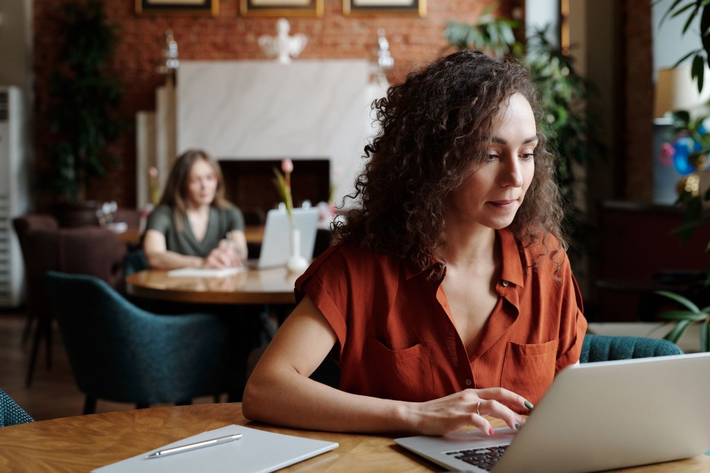 Professional working on a laptop in a modern coworking space