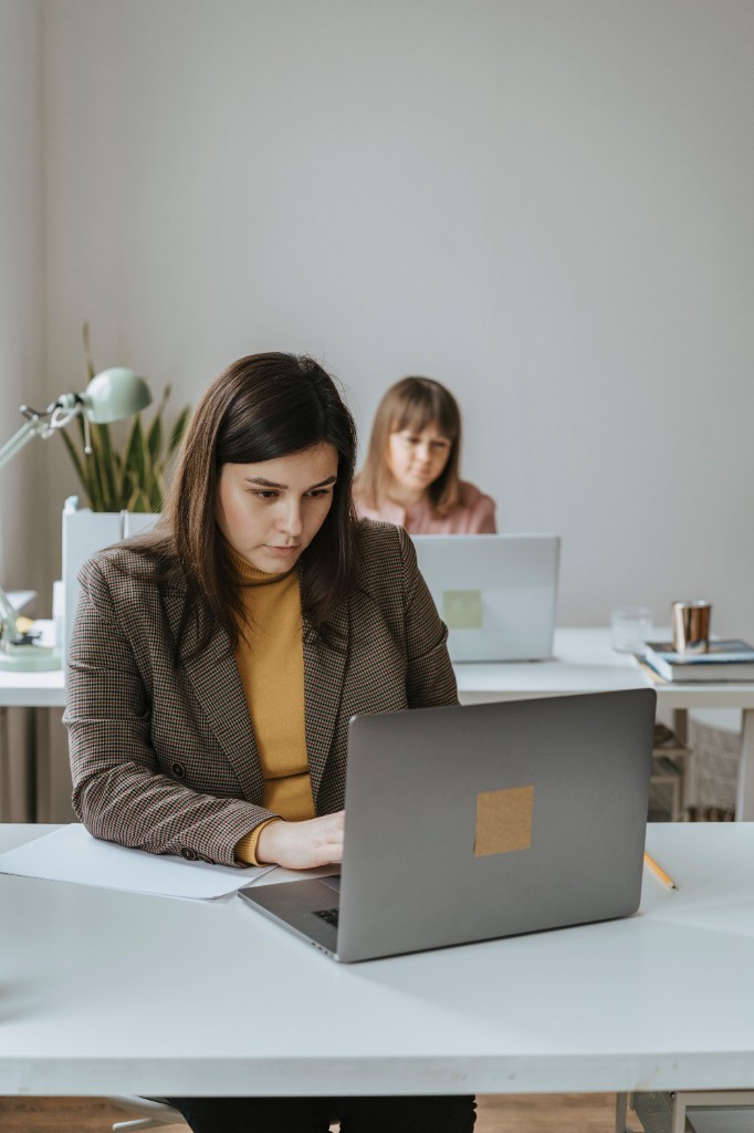 Operators working at laptops in a modern office